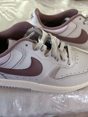 Nike Low-Top Sneakers in White with Mauve Swoosh Accents